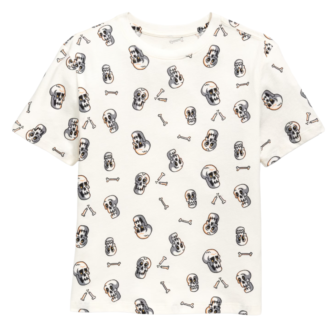 A white T-shirt featuring a pattern of cartoon skulls and bones in black, gray, and orange.