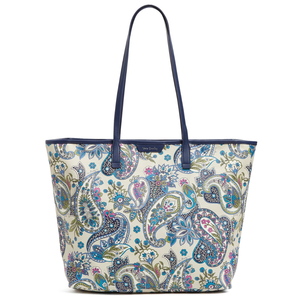 A paisley-patterned tote bag with navy handles and trim, featuring floral and abstract designs in blue, green, and pink hues.