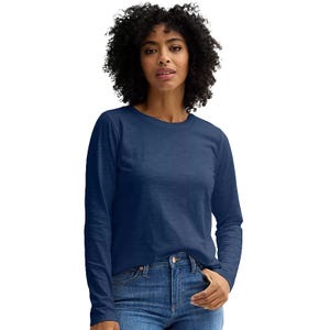 A woman wearing a long-sleeve blue shirt paired with blue jeans.