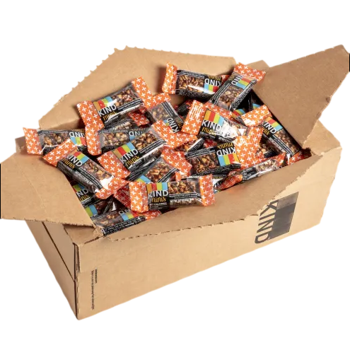A cardboard box filled with individually wrapped KIND bars, featuring colorful packaging and orange star patterns.