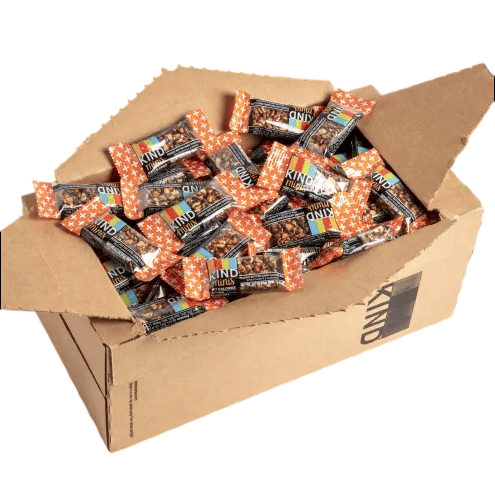 A cardboard box filled with individually wrapped KIND bars, featuring colorful packaging and orange star patterns.