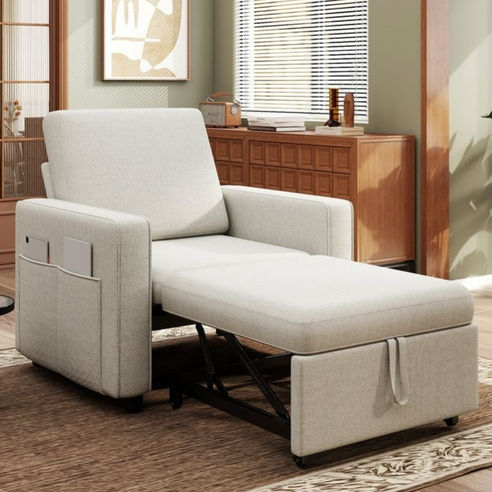 A beige convertible armchair doubles as a recliner, featuring a side pocket for storage. It is set in a modern living room with wooden furnishings and an abstract painting on the wall.