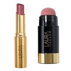 A Laura Geller lipstick with a gold casing next to a black and gold dual-ended blush stick featuring a sponge applicator on one end.