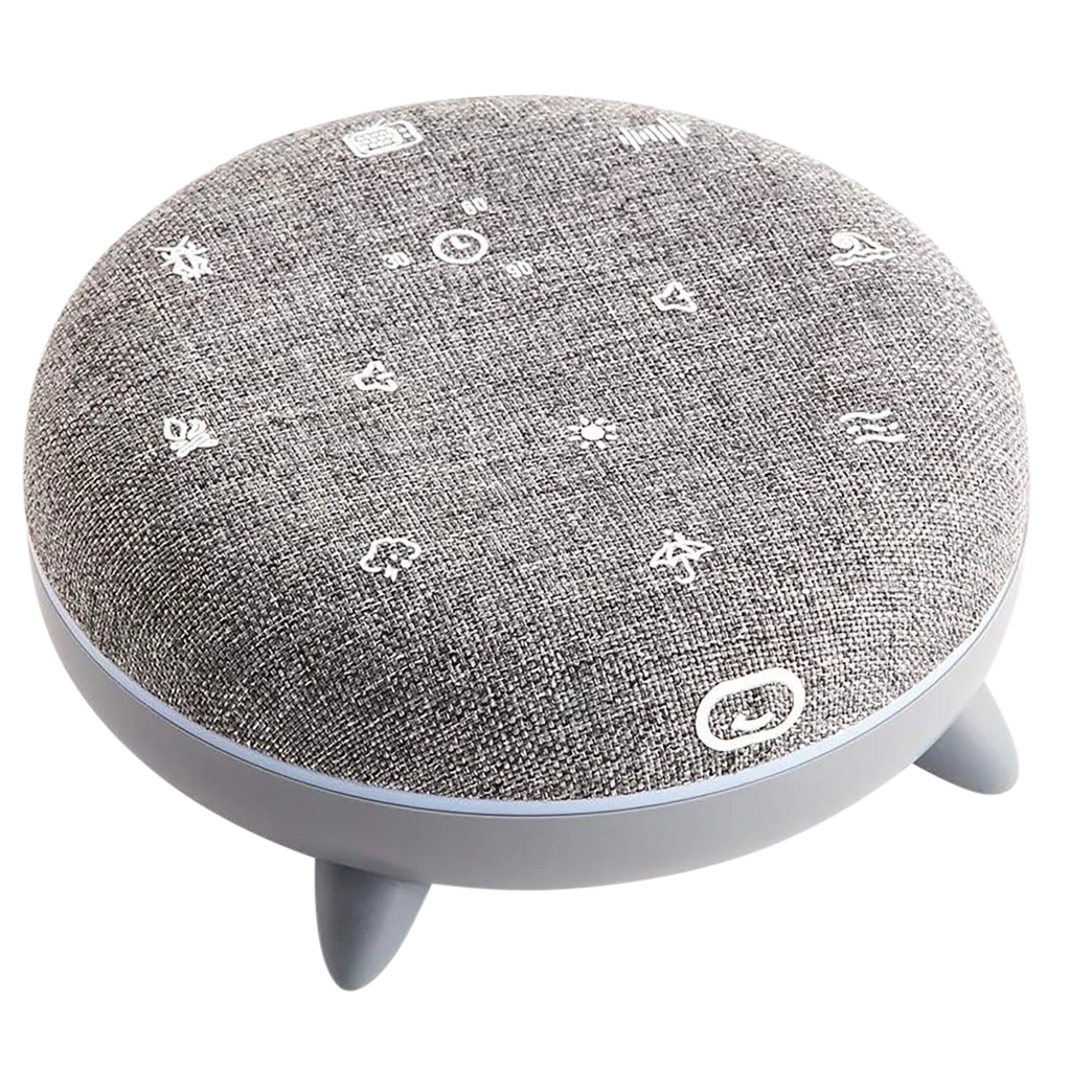 A round device with a fabric top featuring touch-control icons, resting on short legs, serves as a sound machine and night light.
