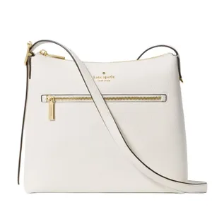 A white leather shoulder bag with a gold zipper and branding details on the front, featuring a long strap for easy carrying.
