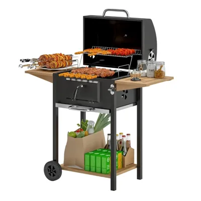 A charcoal grill with skewers, a side shelf holding jars, and storage space below containing groceries and beverages in bags and boxes.