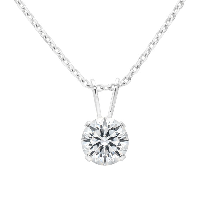 A silver necklace featuring a round-cut 1-carat diamond set in a four-prong minimalist clasp, suspended from a delicate chain.