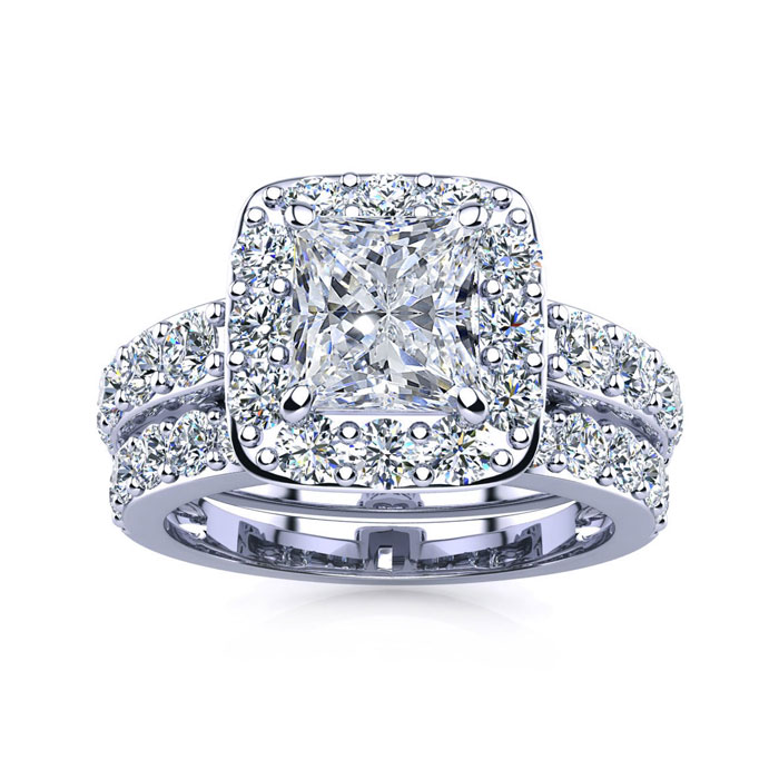 A bridal set featuring a 2.25-carat total weight, with a central princess-cut diamond surrounded by a halo of smaller diamonds, complemented by a matching band adorned with additional diamonds, all set in a silver-toned metal.