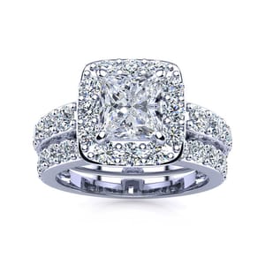 A bridal set featuring a 2.25-carat total weight, with a central princess-cut diamond surrounded by a halo of smaller diamonds, complemented by a matching band adorned with additional diamonds, all set in a silver-toned metal.