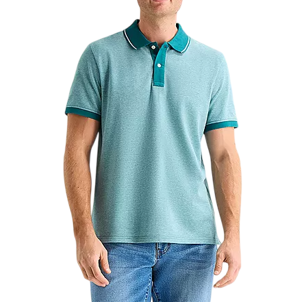 A man wearing a light teal polo shirt with teal accents on the collar and sleeves, paired with blue jeans.