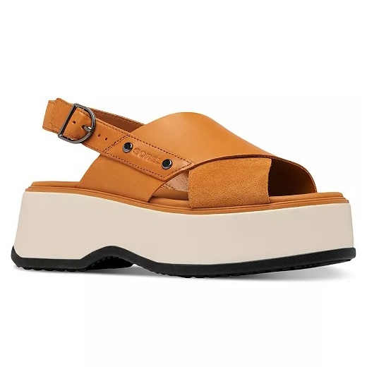 A tan platform sandal featuring a closed toe, open heel, and adjustable ankle strap. The shoe has a white chunky sole with a black bottom.