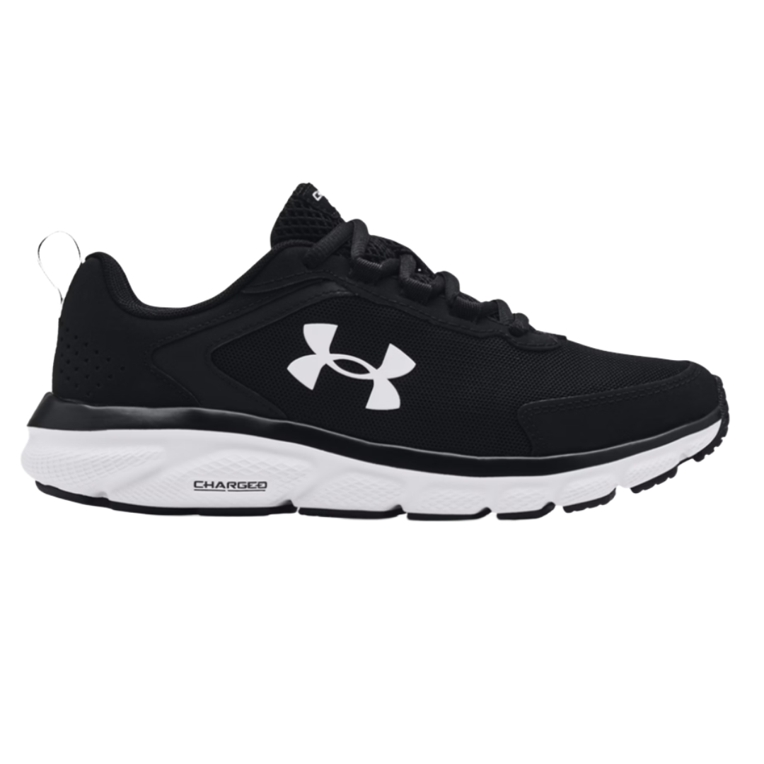 A black and white Under Armour athletic shoe with a logo on the side, featuring a cushioned sole labeled \“Charged\“ for enhanced support.
