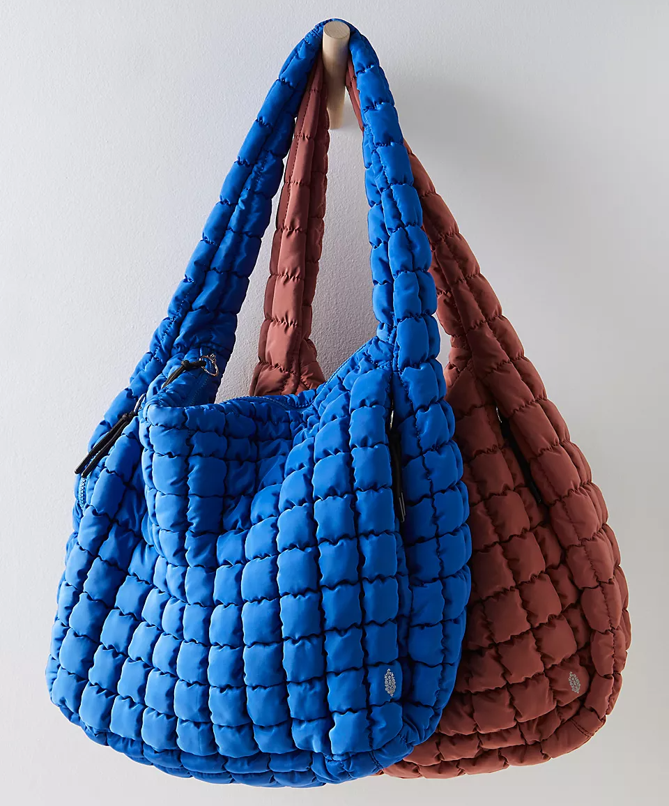 Two quilted shoulder bags, one blue and one brown.