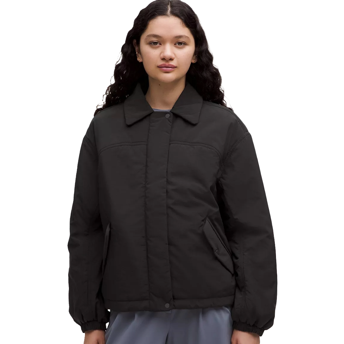 Lululemon Insulated Collared Jacket features a minimalist design with a collared neckline, button closure, and side pockets. It is made with insulating material for warmth and has a relaxed fit.