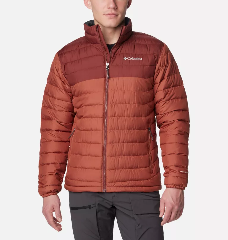 A man is wearing a Columbia brand insulated jacket in a burnt orange color.