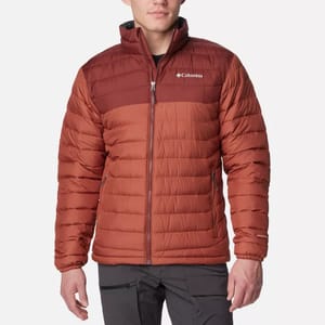 A man is wearing a Columbia brand insulated jacket in a burnt orange color.