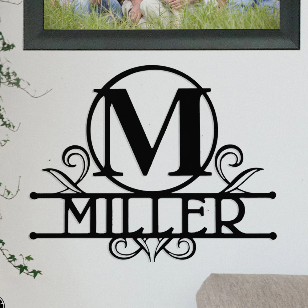 A wall decoration features a black monogram design with the letter \“M\“ in a circle and the word \“Miller\“ beneath, adorned with decorative swirls.