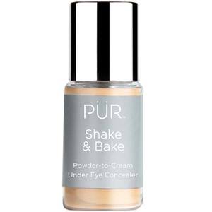 PÜR Shake & Bake is a powder-to-cream under eye concealer with a silver cap and gray label, designed to reduce the appearance of under-eye imperfections.