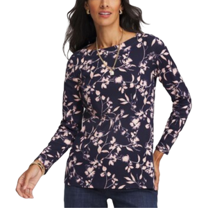 A woman is wearing a long-sleeve, navy blue shirt with a light pink floral pattern.