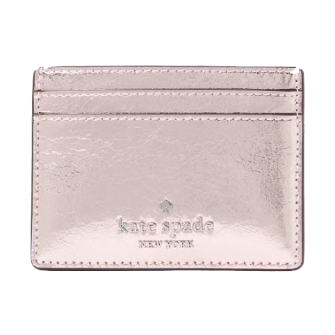 A metallic pink Kate Spade New York cardholder with two card slots and embossed branding.