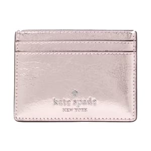 A metallic pink Kate Spade New York cardholder with two card slots and embossed branding.