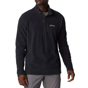A man wearing a black quarter-zip fleece pullover with a logo on the chest.