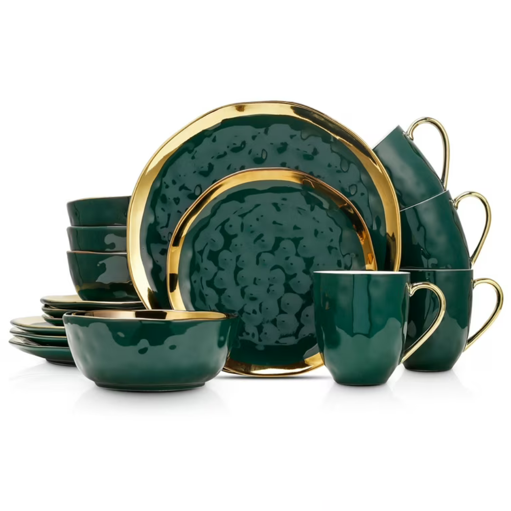 Green dinnerware set with gold accents includes plates, bowls, and mugs, featuring a textured design.
