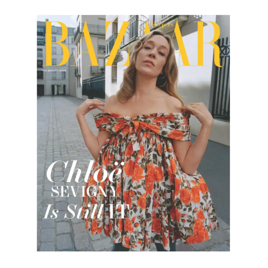 A Harper's Bazaar cover features a person in a floral off-the-shoulder dress with orange and red roses. Text reads, \“Chloë Sevigny Is Still IT,\“ highlighting the beauty issue theme.