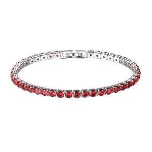 A tennis bracelet featuring a series of linked, round red gemstones set in a silver metal band with a clasp for fastening.