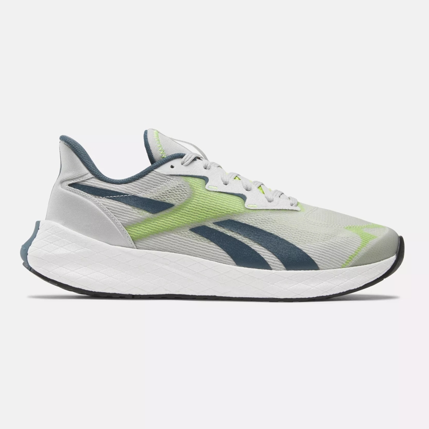 A running shoe with a white sole, grey upper, and accents in shades of green and navy blue.
