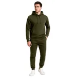 A person is wearing an olive green hoodie and matching jogger pants with white sneakers.