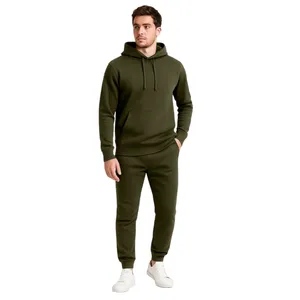 A person is wearing an olive green hoodie and matching jogger pants with white sneakers.