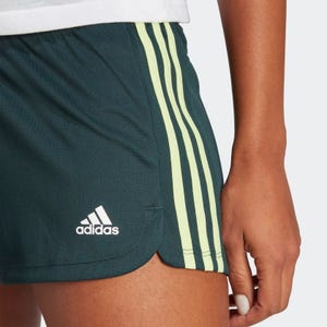 Green Adidas shorts with white stripes and logo.