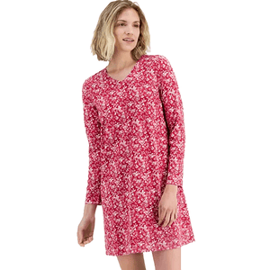 A woman is wearing a long-sleeve, pink floral-patterned dress with a V-neck.