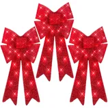 Three red glittery holiday bows with long tails and sparkling accents.