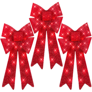 Three red glittery holiday bows with long tails and sparkling accents.