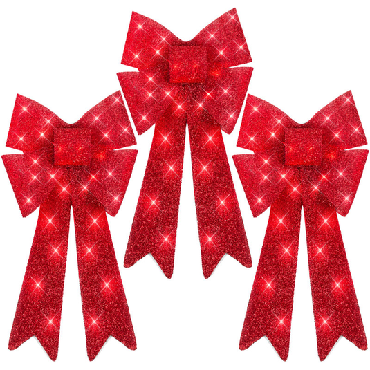 Three red glittery holiday bows with long tails and sparkling accents.