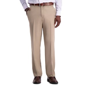 A person wearing beige dress pants with a brown belt, checkered dress shirt, and brown shoes.