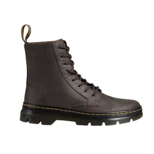 A brown leather lace-up boot with a rugged sole and a yellow-stitched welt, featuring a distinctive pull tab at the heel.