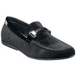 A black velvet loafer with a sleek design, featuring a decorative metallic buckle and braided detail across the front.