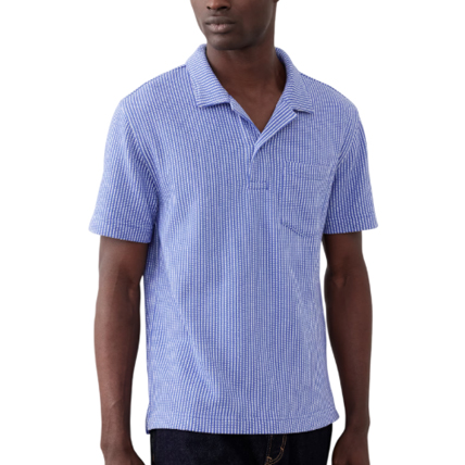 A short-sleeve blue seersucker polo with a spread collar, featuring a textured stripe pattern and a single chest pocket.