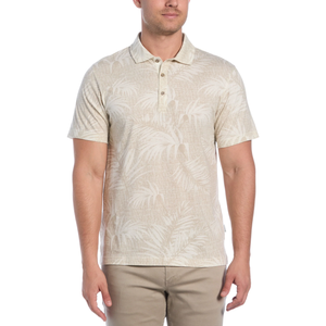A light beige polo shirt with a tonal palm tree pattern, short sleeves, and a buttoned collar, paired with beige pants.
