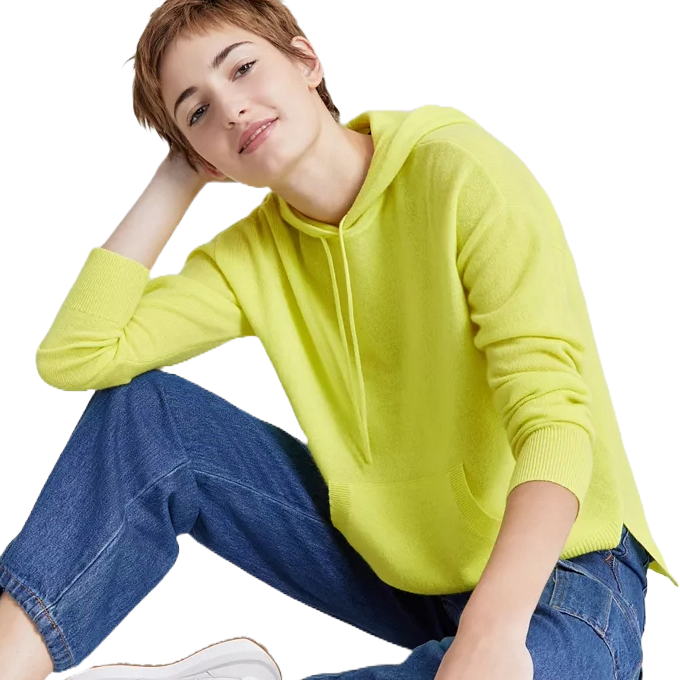 A person wearing a bright yellow hoodie paired with blue jeans and white shoes is posing casually.