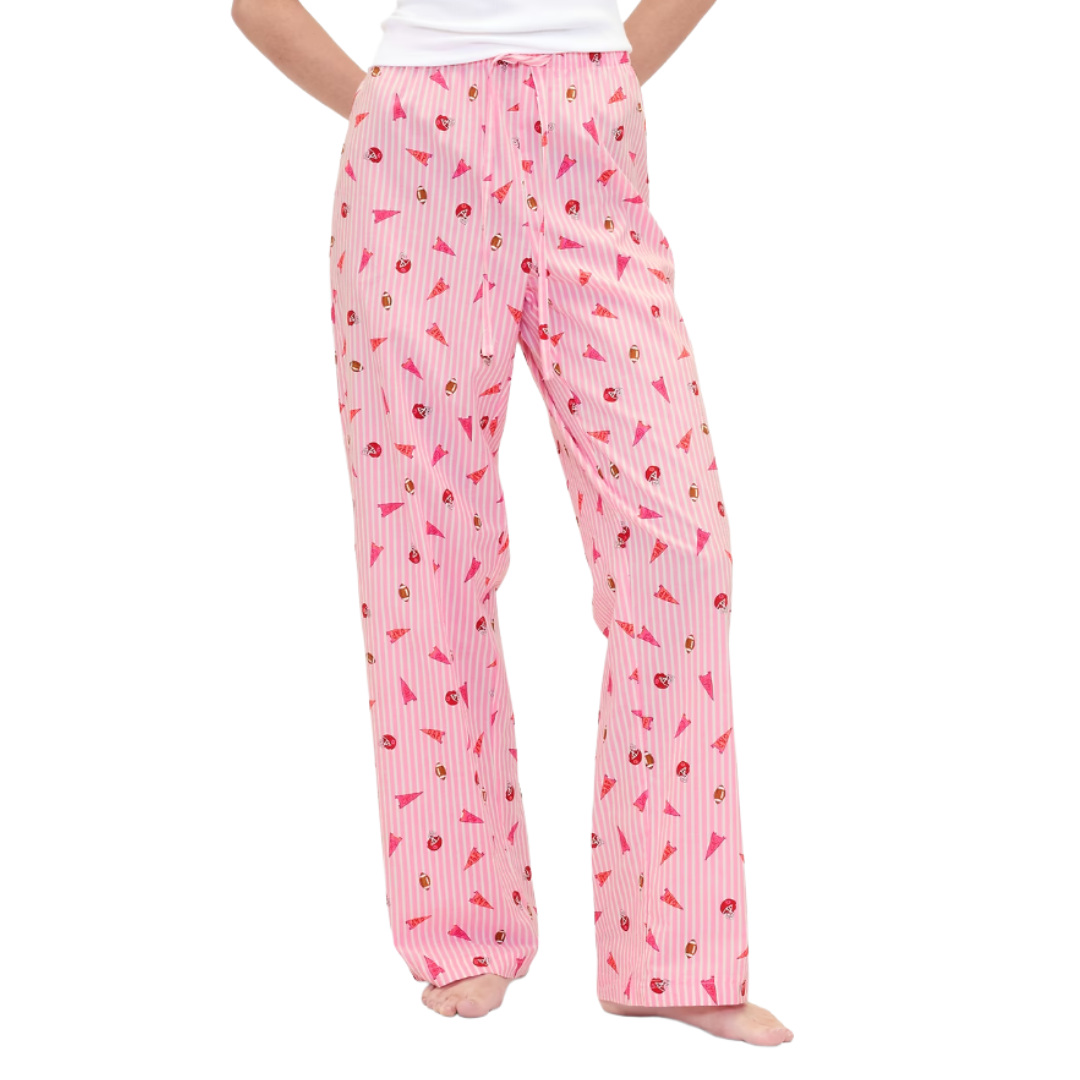 Pink pajama pants with a drawstring waist, featuring a pattern of ice cream cones, stripes, and small brown icons.