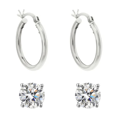 A pair of silver hoop earrings and two round-cut diamond stud earrings.