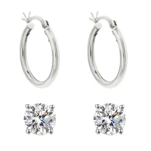 A pair of silver hoop earrings and two round-cut diamond stud earrings.