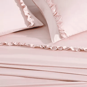 Pink queen sheet set with ruffle trim includes pillowcases and sheets, featuring a soft, elegant design.