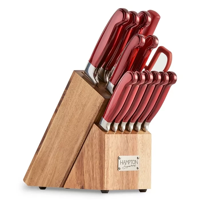 A 14-piece set of Hampton Forge cutlery with red handles, including various knives and kitchen shears, housed in a wooden block.