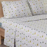 Gray bed sheet set with a playful print featuring polar bears and penguins wearing scarves, along with small houses and trees.