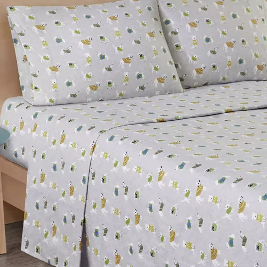 Gray bed sheet set with a playful print featuring polar bears and penguins wearing scarves, along with small houses and trees.